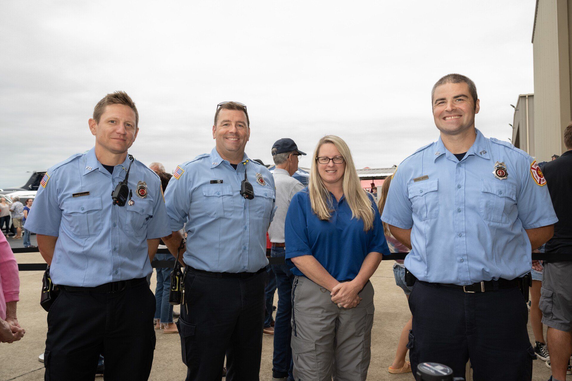 A group of firefighters are posing for a picture together.
