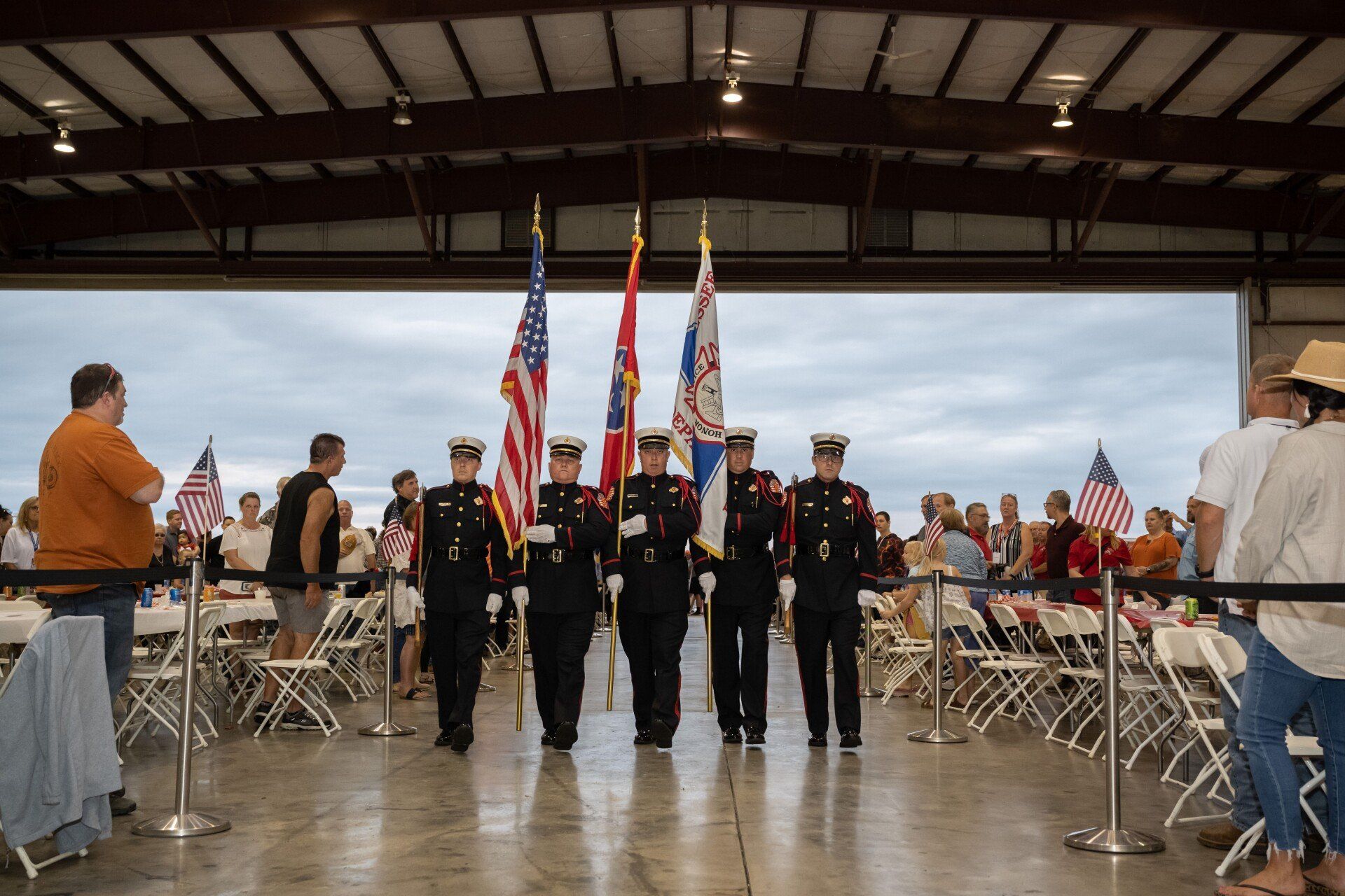 A group of soldiers marching in a line with flags