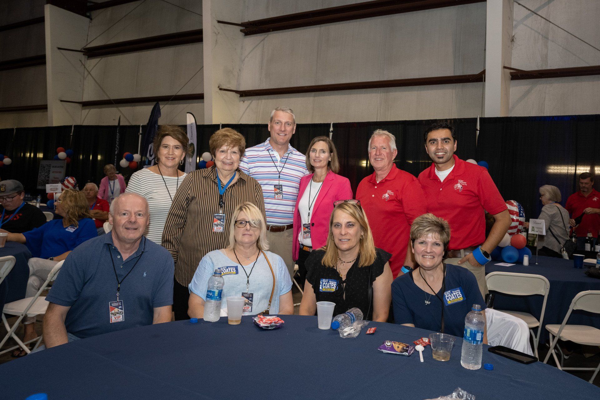 A group of people are posing for a picture at a table.