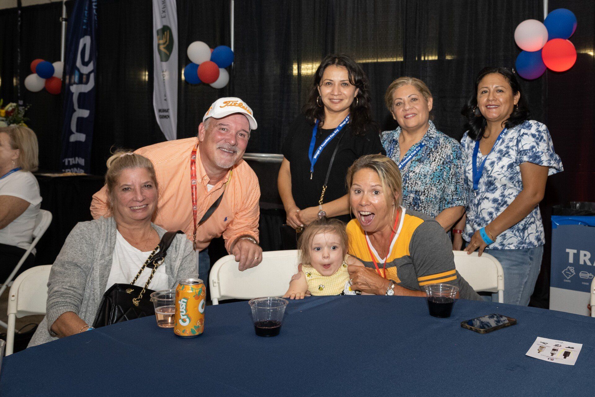 A group of people are posing for a picture at a table.