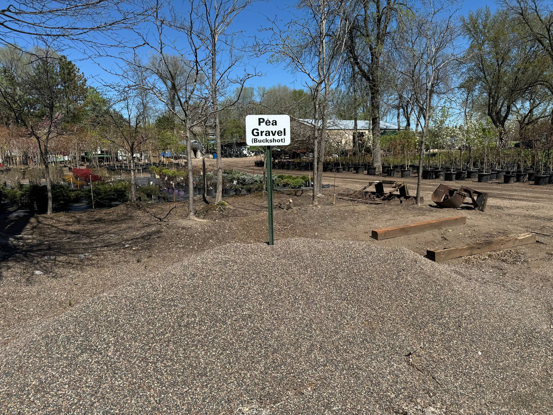 A gravel area with a sign in the middle of it.