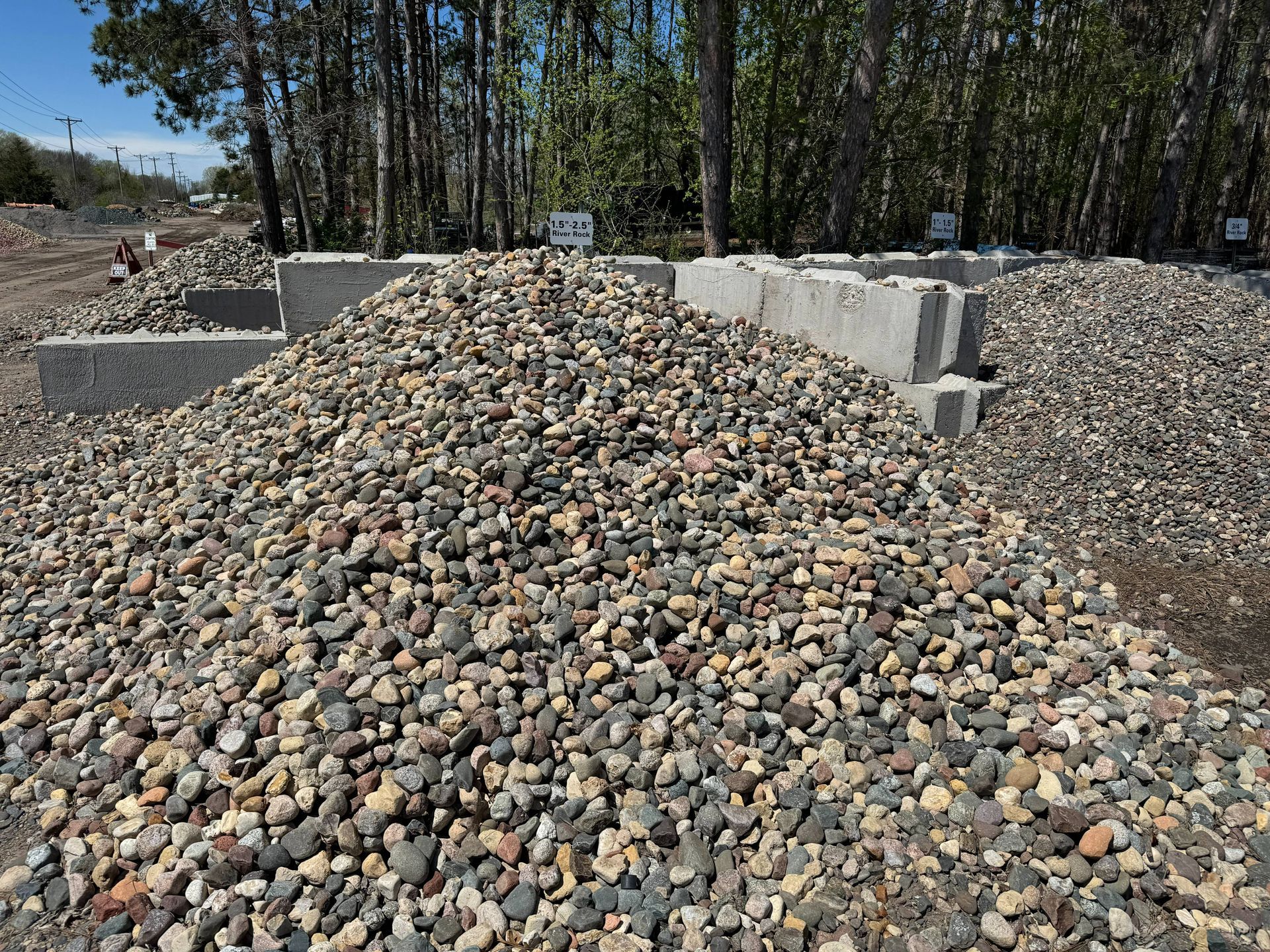 A pile of gravel is sitting on top of a dirt field.