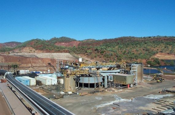 An aerial view of a construction site with mountains in the background