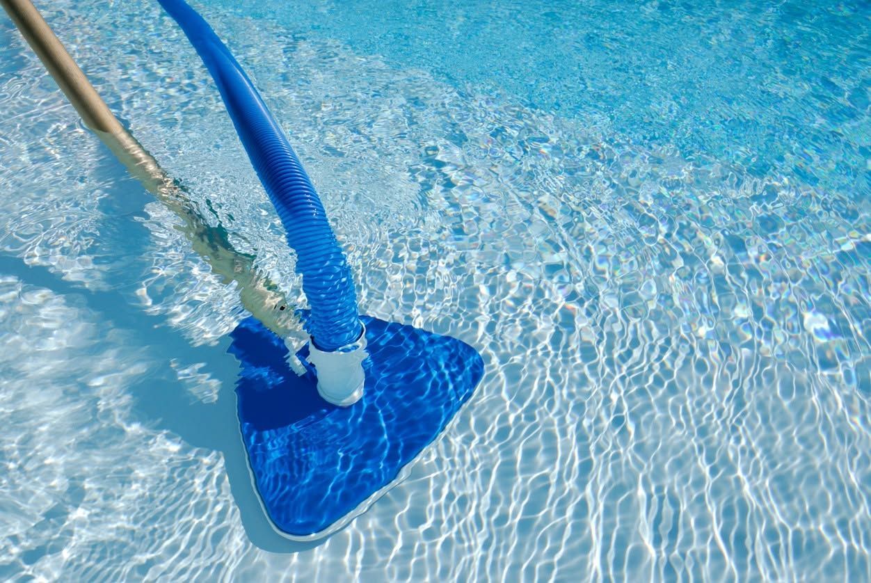 Blue pool vacuum head cleaning clear water, with hose attached.