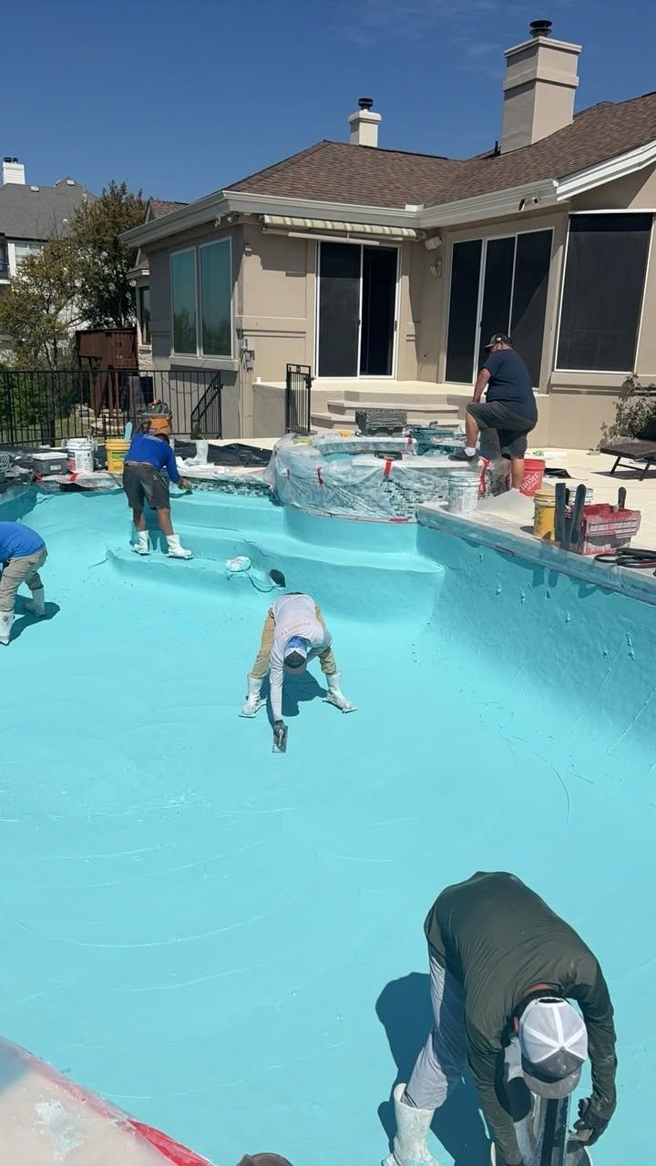 Backyard pool scene with children and dogs in and around a bright blue swimming pool near a house