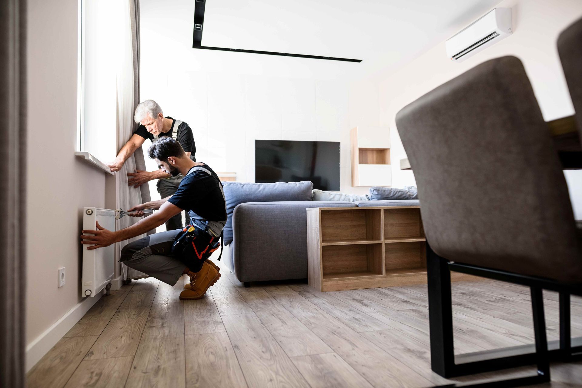 Heating installation service upgrading a home's indoor heating system.