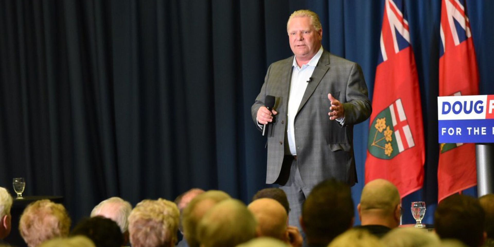 Doug Ford is giving a speech in front of a crowd.