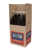 A cardboard box filled with clothes and a hanger.