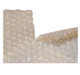 A pile of clear plastic beads on a white surface.