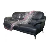 A black leather couch wrapped in plastic on a white background.