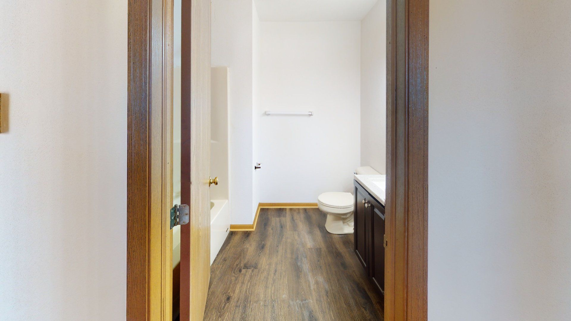 A bathroom with a toilet , sink , and bathtub.