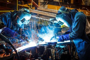 Worker with Protective Mask Welding Metal