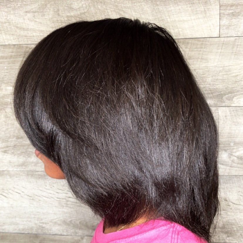 Woman Braiding Hair — Riverside, CA — Mahogany Designs Unlimited Beauty Salon