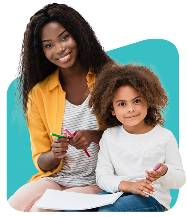 Woman and child sitting together, both holding crayons, smiling.