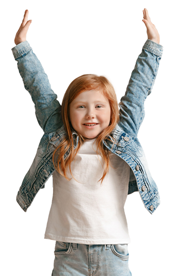 Girl with red hair wearing a jean jacket and white shirt, arms raised.