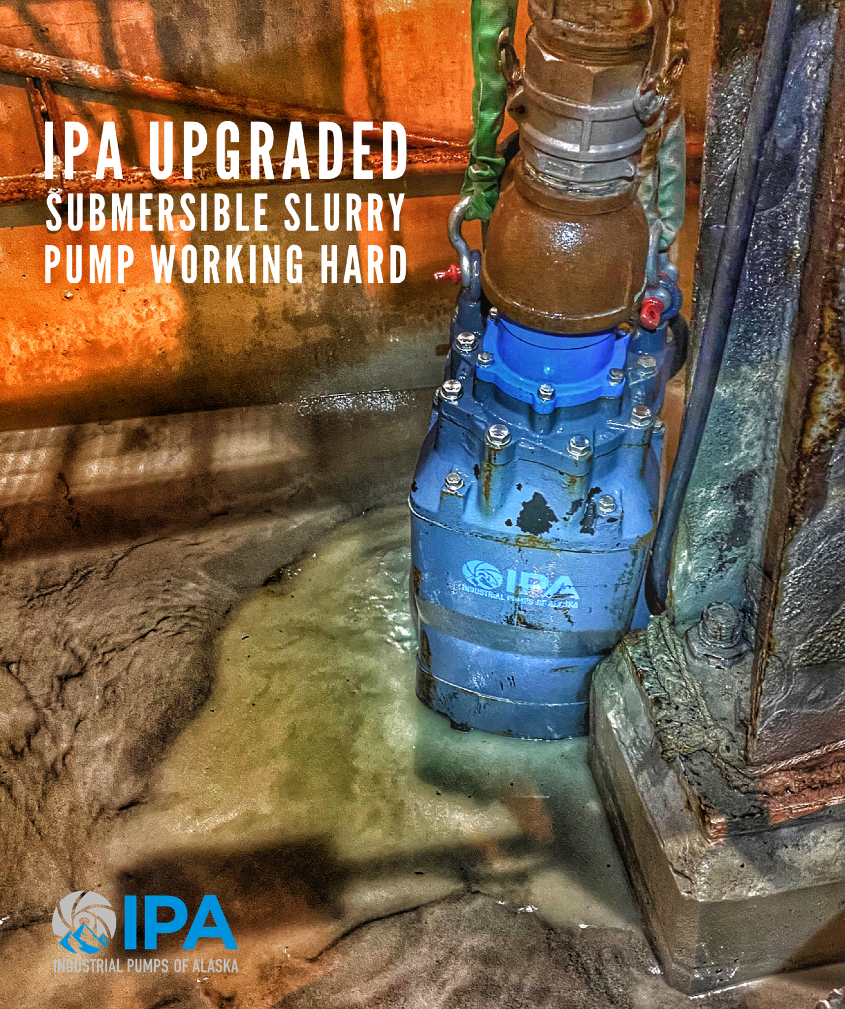 A blue submersible slurry pump is working hard