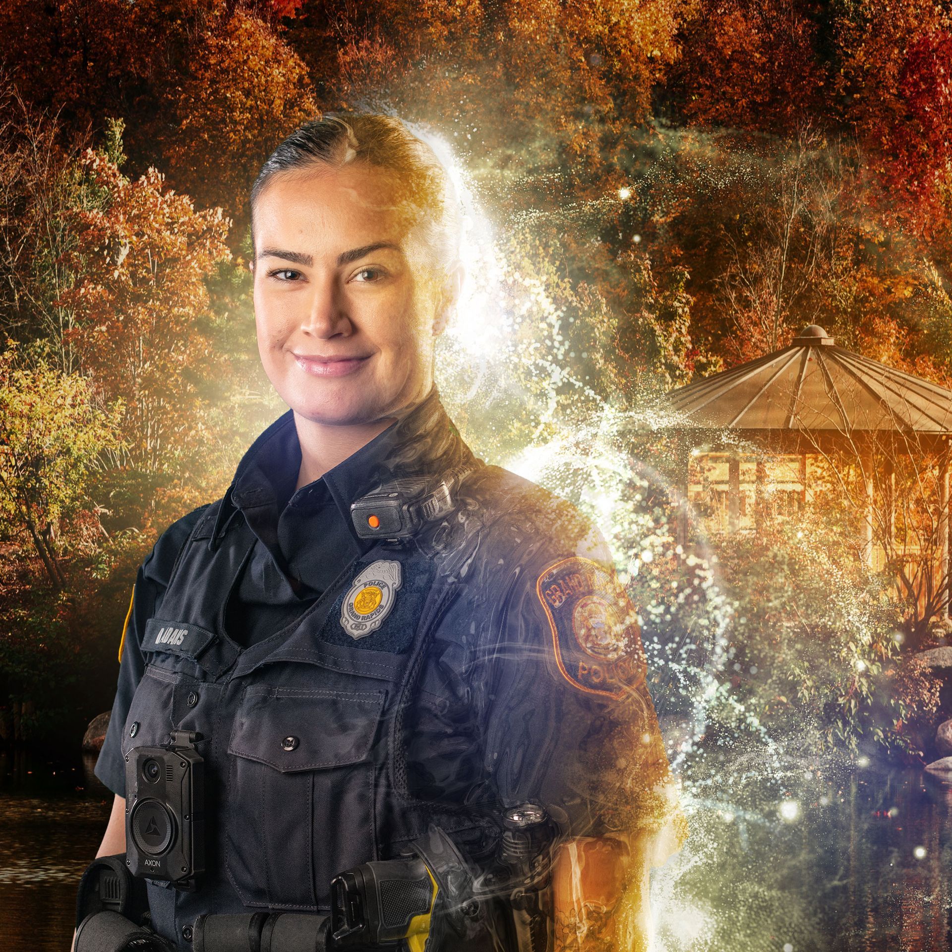 Police officer smiling outdoors with park-like scenery and a bright, glowing effect.
