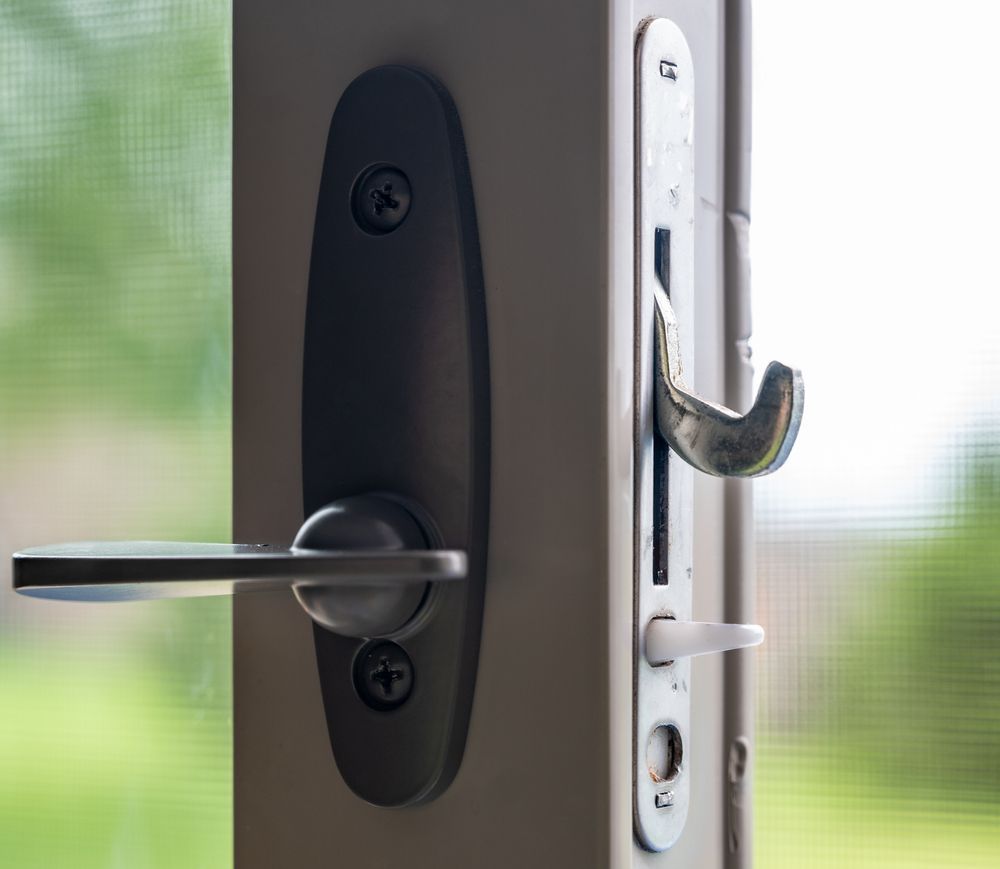 Close-up of a Door Handle and Latch on a White Frame — Rohan's Maintenance in Robina, QLD