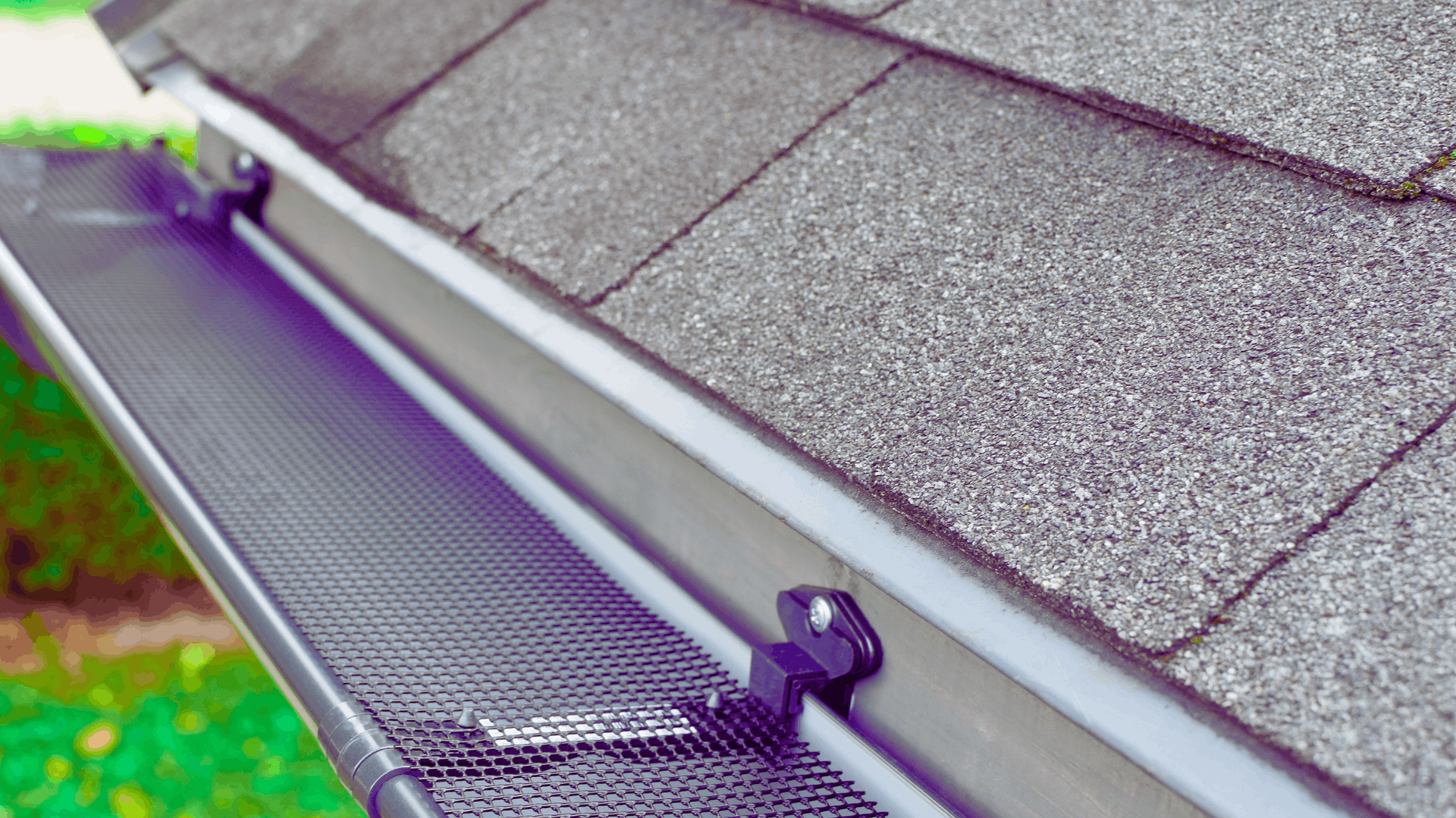 Gutter with mesh cover installed on a roof, protecting against debris — Rohan's Maintenance in Robina, QLD