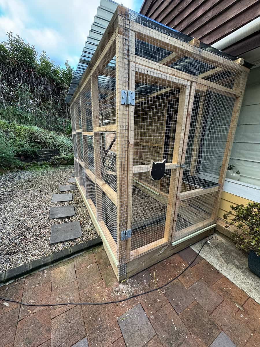 Wooden Outdoor Animal Enclosure With Wire Mesh on a Brick Patio Beside a Garden Path — Catios By Paulie in Blackbutt, NSW