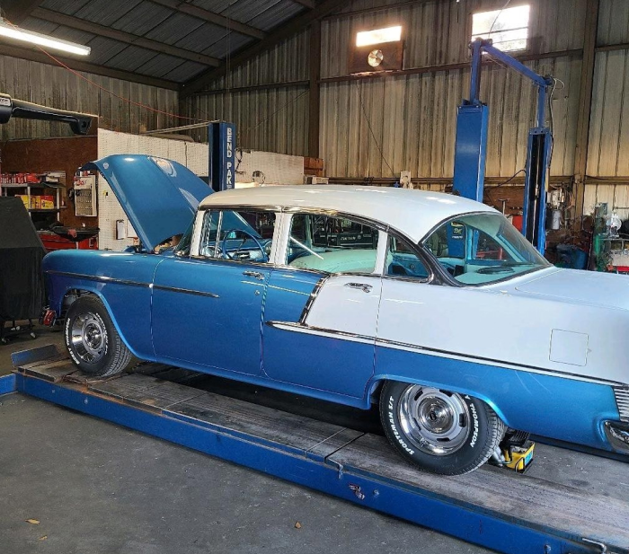 Blue and white classic car with hood up in garage in Bloomingdale, GA | Elton's Auto