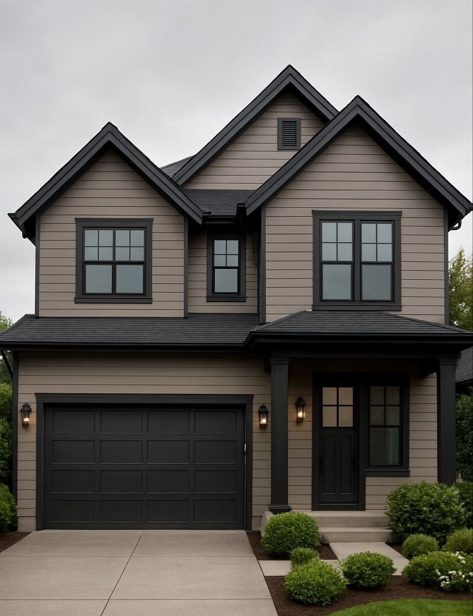 Modern two-story gray house with black trim, a front porch, and an attached garage.