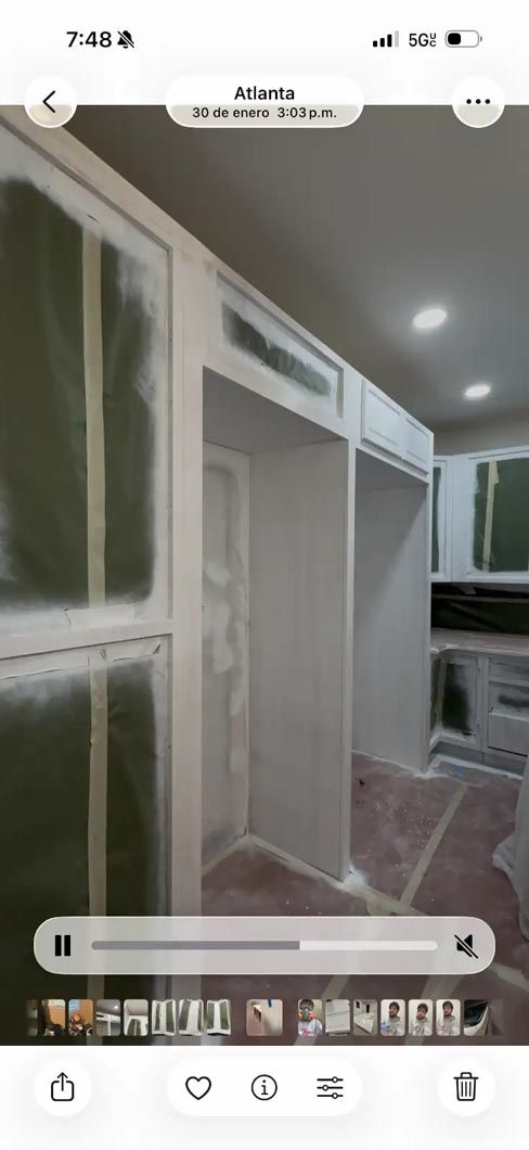 White built-in wardrobe cabinets with open shelving in a bedroom or dressing area