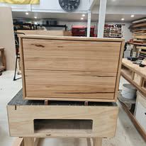 Wooden cabinet on a workbench in a woodworking shop
