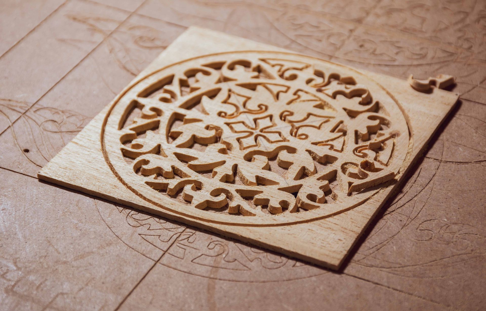 Wooden carved circular mandala panel on a beige tiled floor