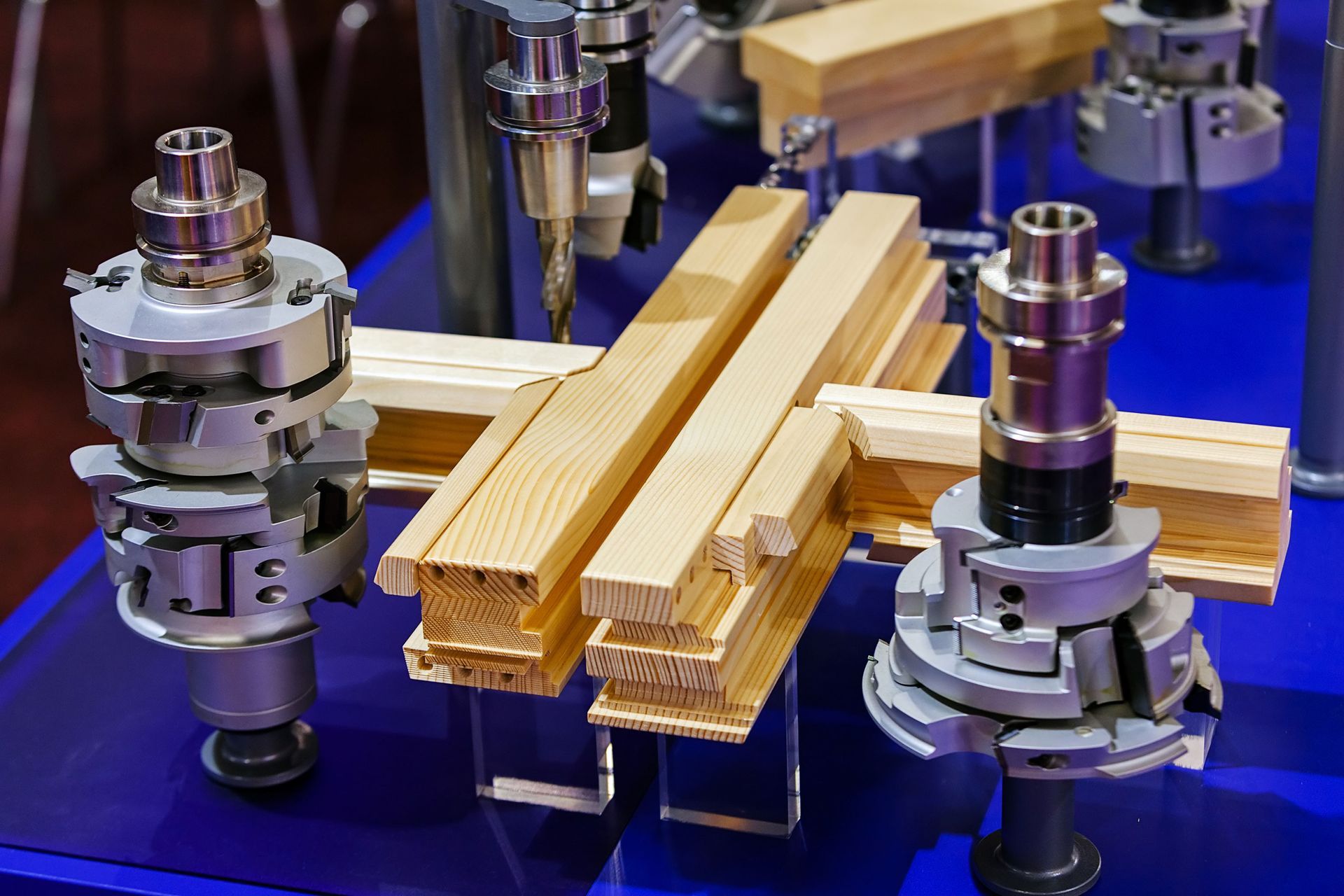 Wooden beams clamped in a metal testing rig on a blue workbench