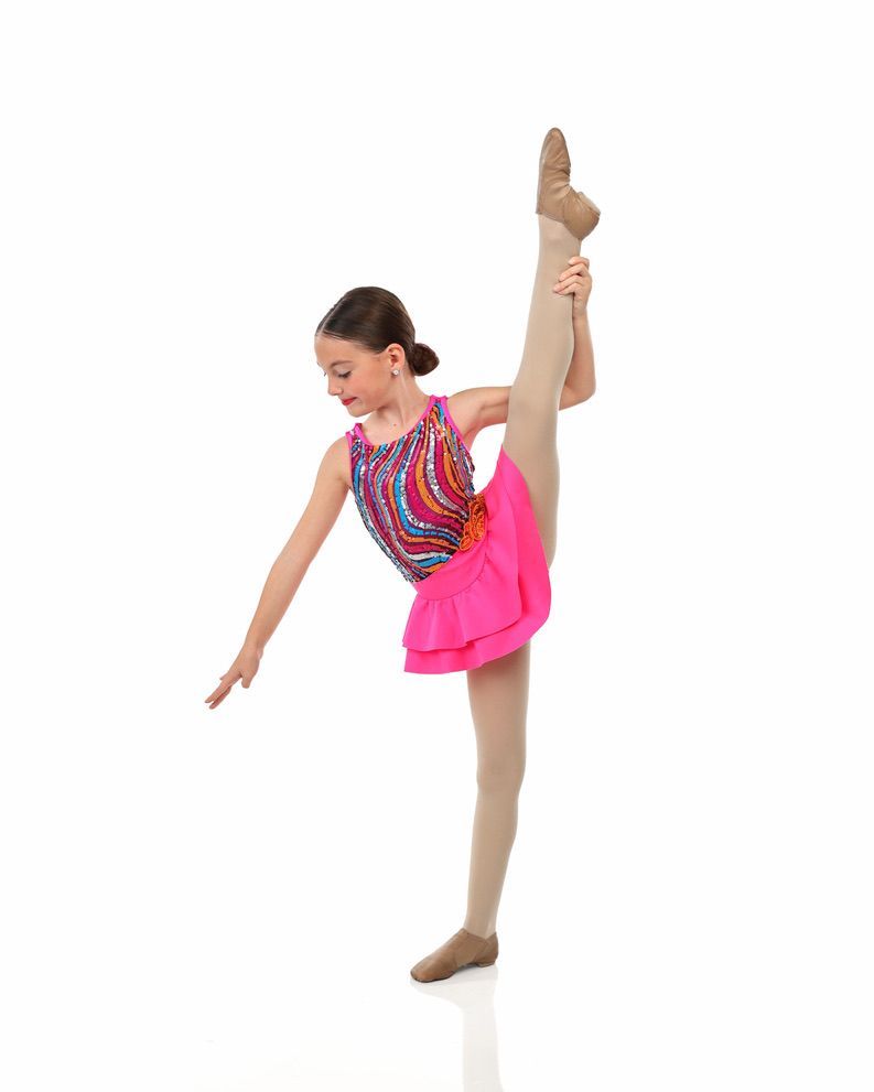 Young dancer in bright pink costume balancing in a high leg hold against a white background
