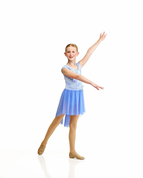 Dancer in a blue gown posing in a studio on a white background