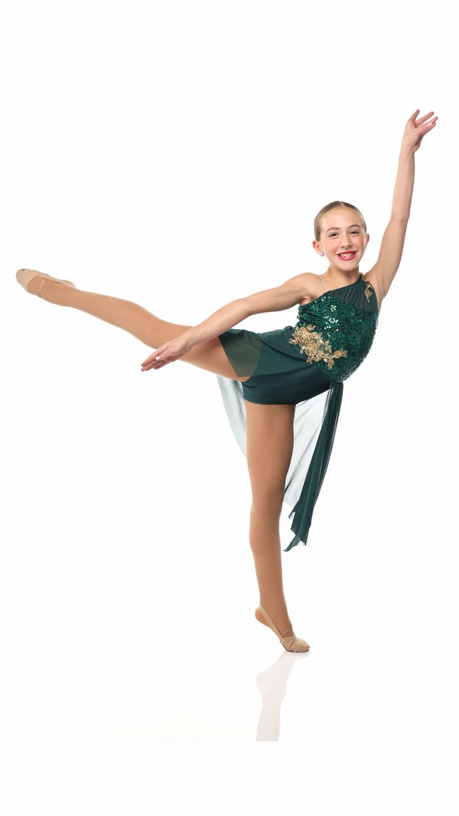 Young gymnast in a green costume balancing on one leg with arms outstretched on a white background