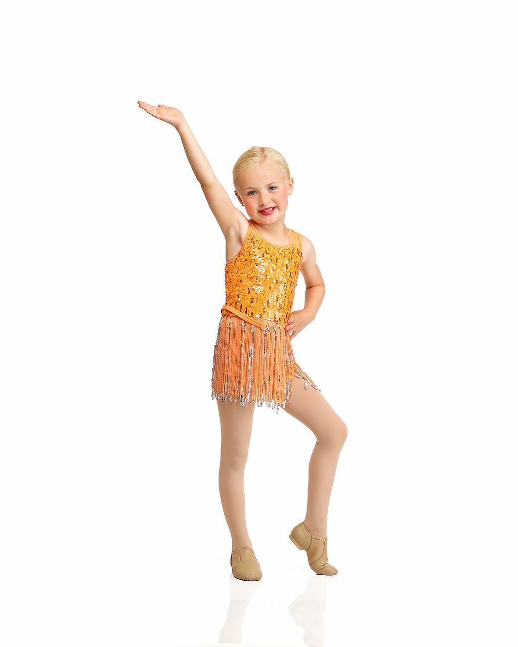 Young dancer in orange costume posing with one arm raised against a white background