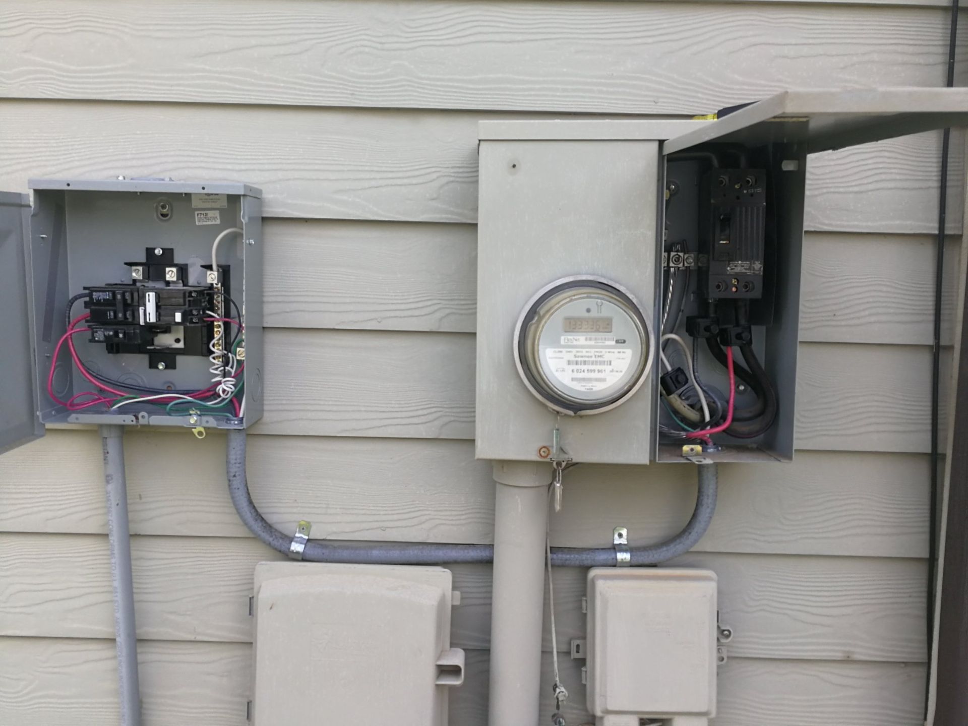 There is a meter on the side of a house.