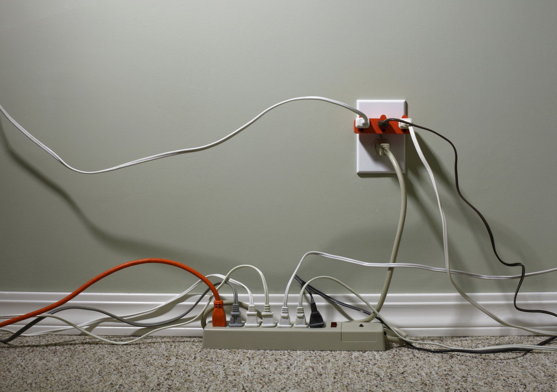 A bunch of wires are plugged into a power strip