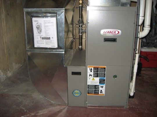 A lennox air conditioner is sitting in a basement