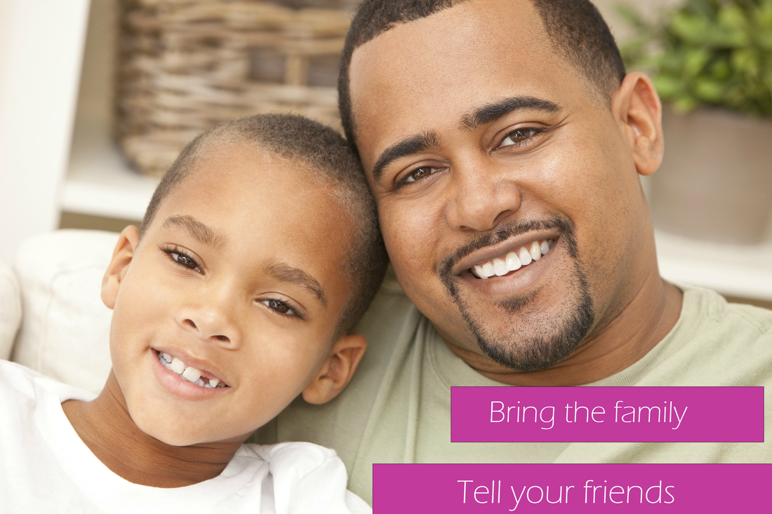 A man and a boy are sitting next to each other and smiling.