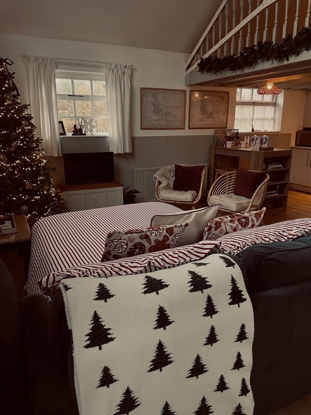 LaplandUK Cozy living room with Christmas tree, patterned chairs, and festive holiday decor