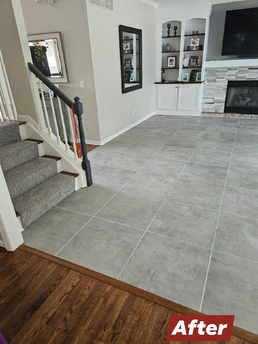Living room with large gray tile floor, fireplace, built-in shelves, and staircase; “After” label in corner