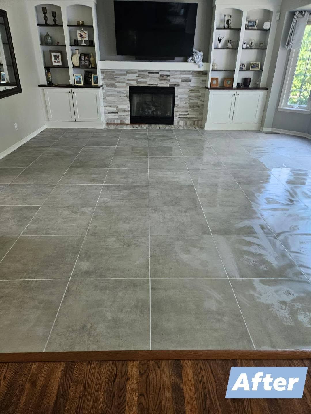 Living room with large gray tile floor and fireplace, labeled “After”