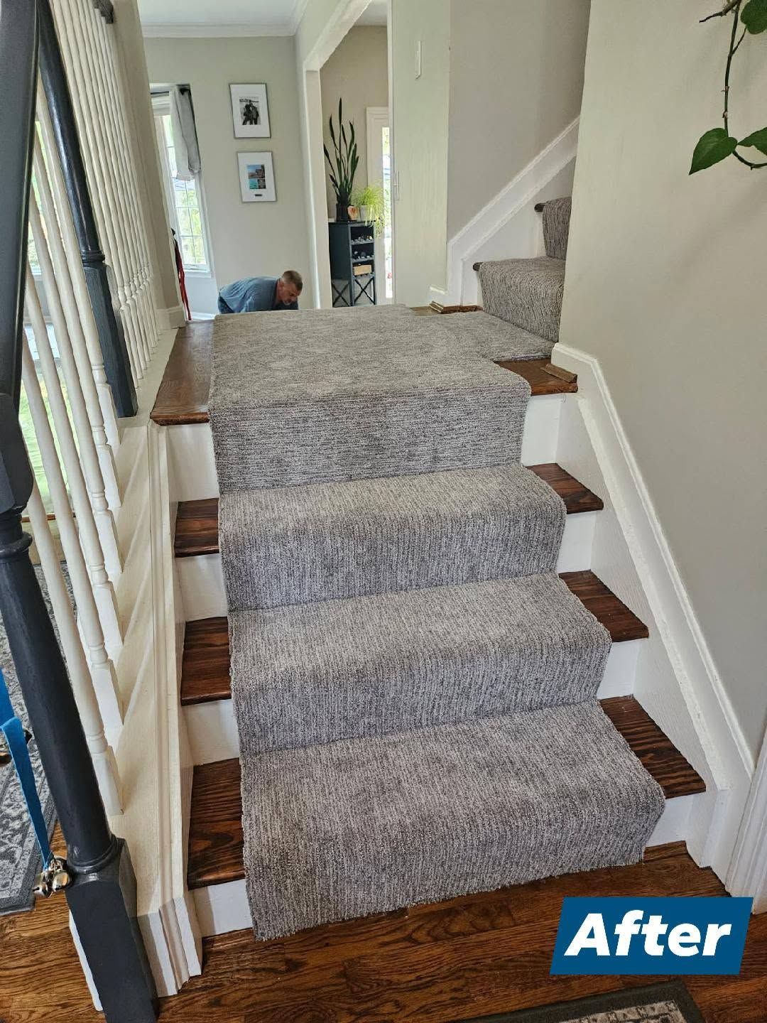 Carpeted staircase with wooden trim in a hallway, labeled “After” in the corner.