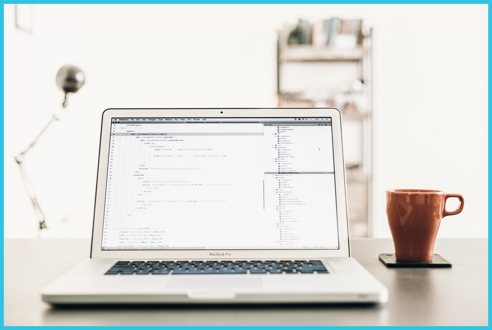 A laptop is open on a desk next to a cup of coffee