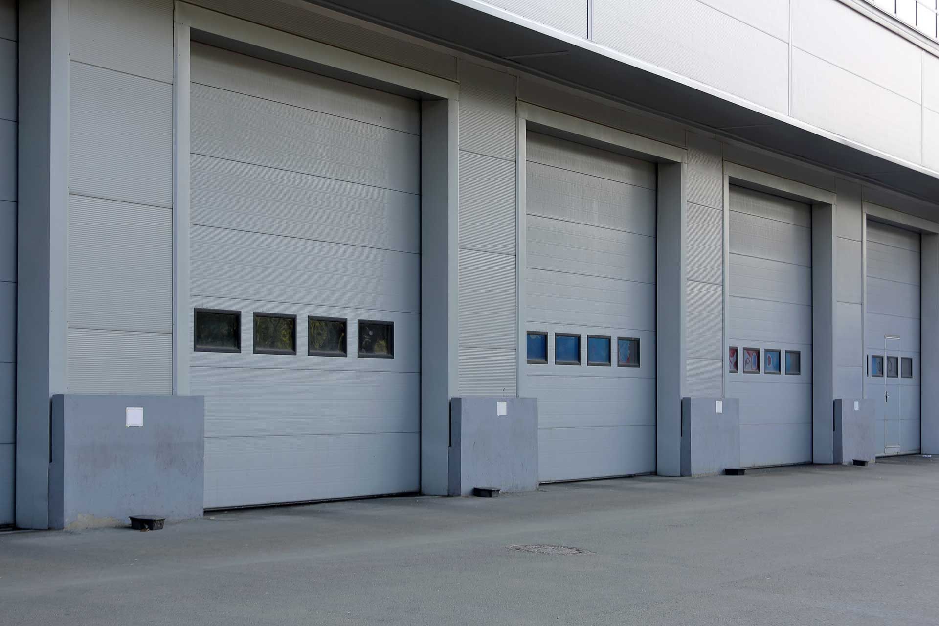 A row of garage doors on the side of a building.