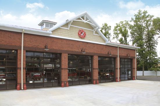 A large brick building with a lot of garage doors.