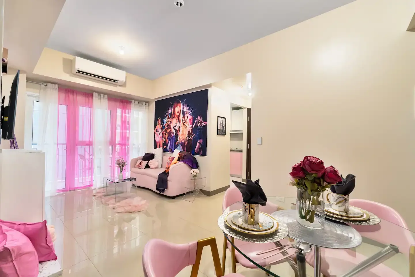 A living room with a dining table and chairs and a couch at Bayshore Luxe by Prime, Manila