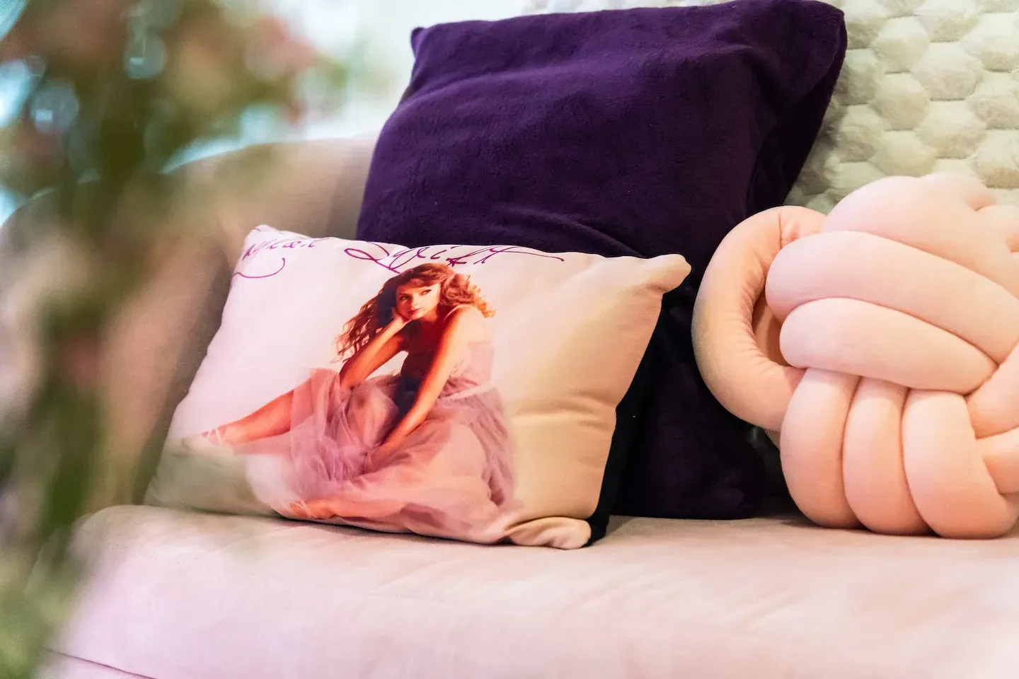 A pillow with a picture of Taylor Swift on it is sitting on a couch at Bayshore Luxe by Prime, Manila