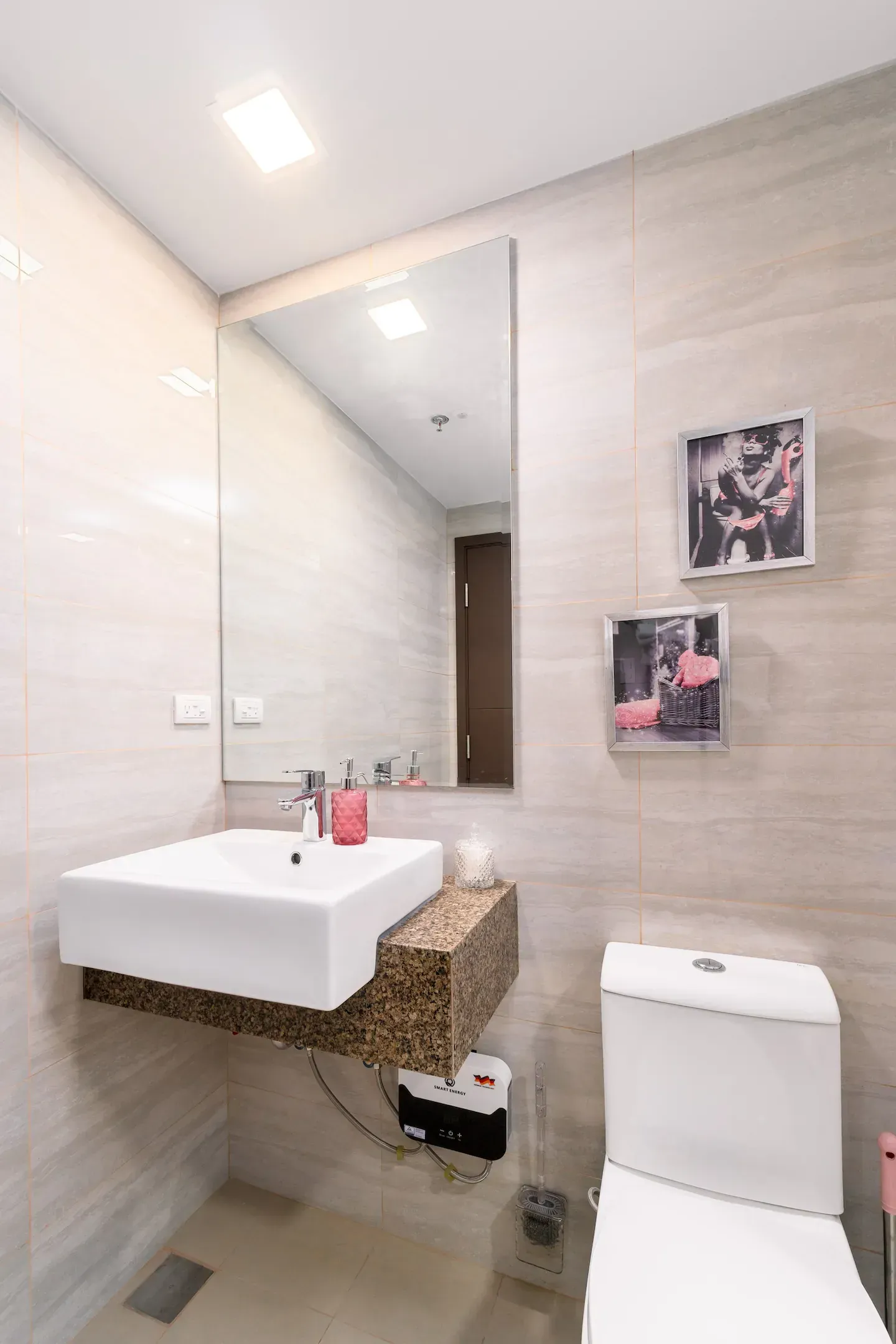 A bathroom with a sink , toilet and mirror.