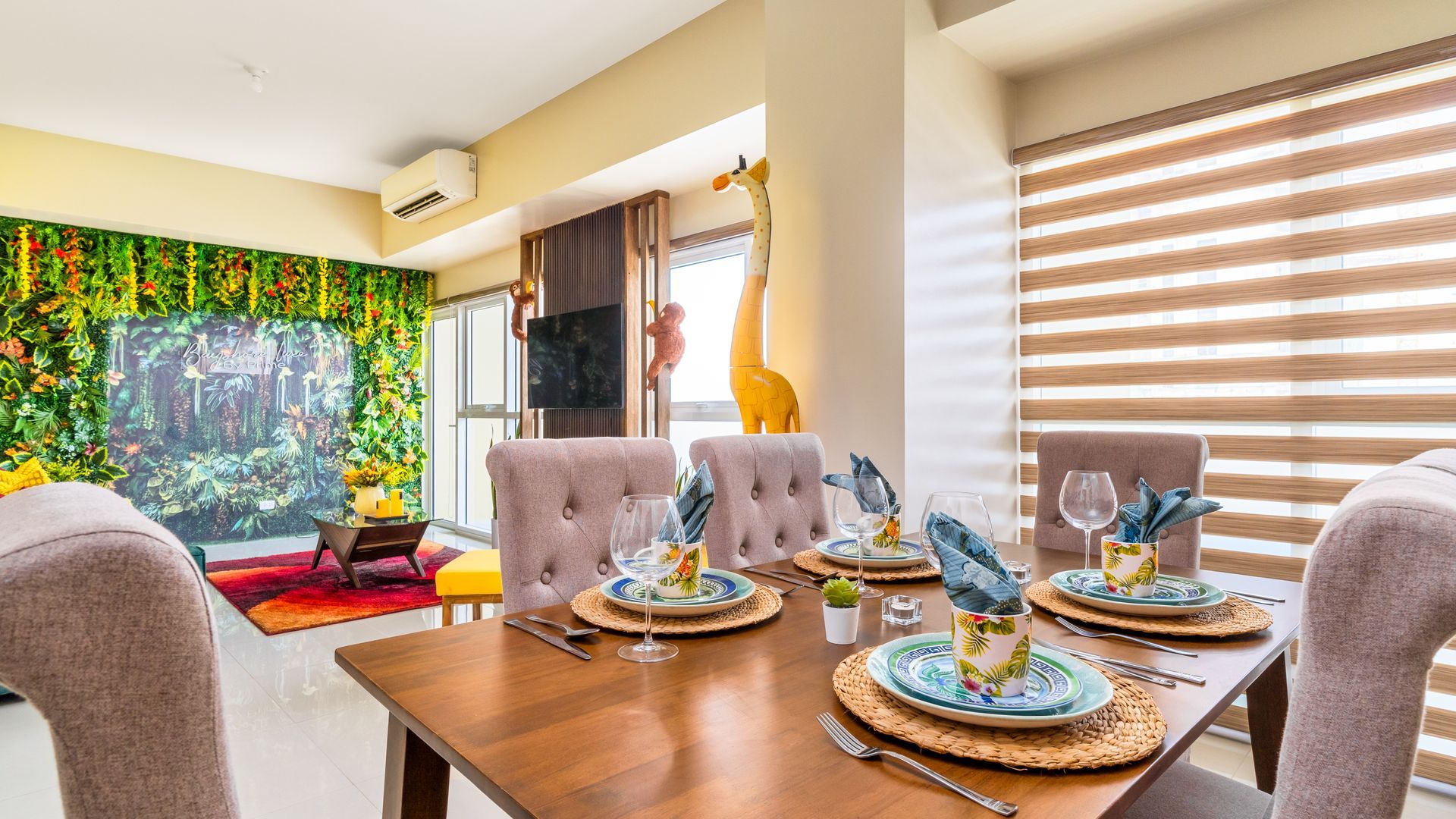 Dining table with faux suede beige chairs and tropical plates  and cups