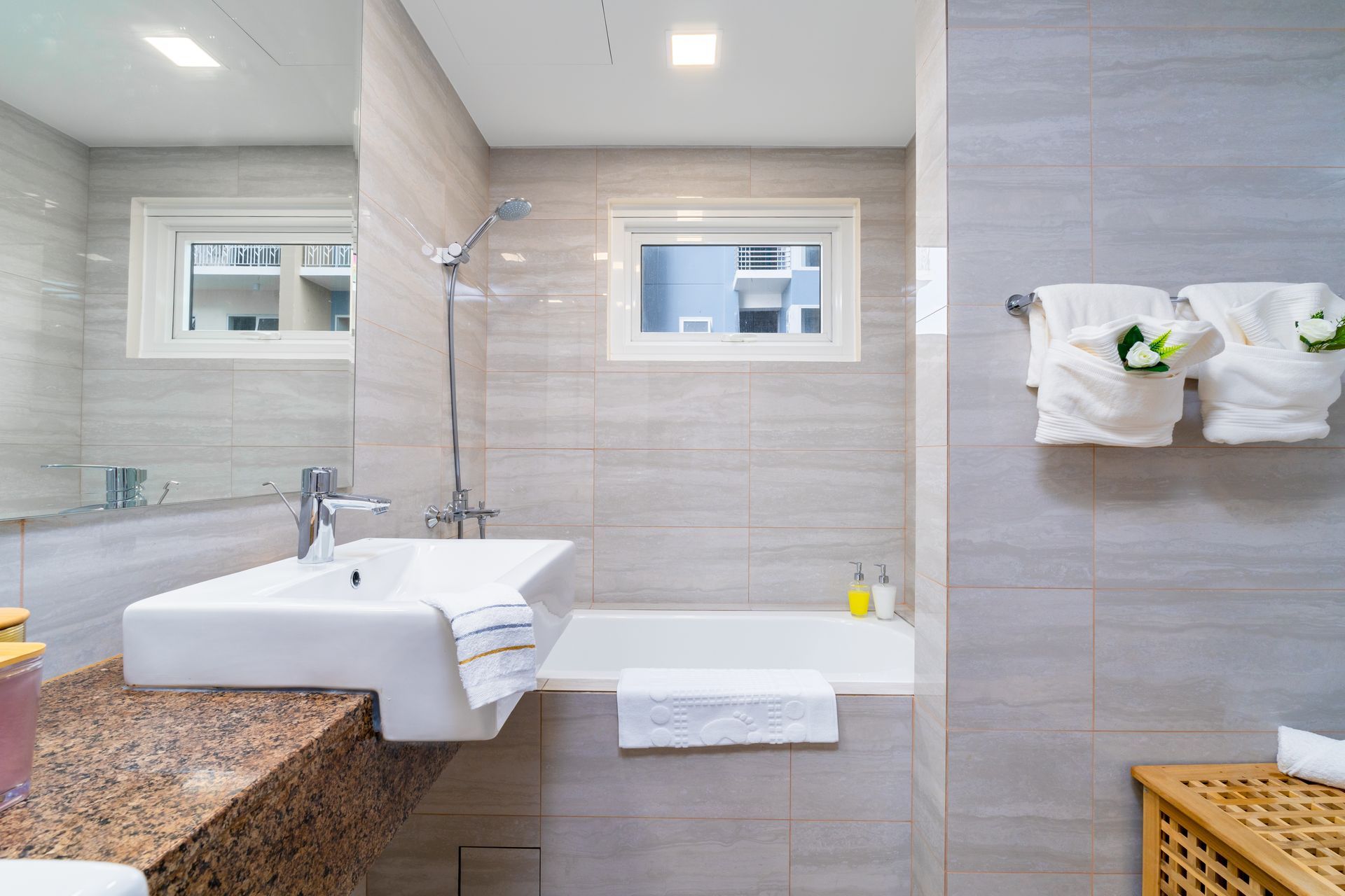 A bathroom with a sink , bathtub , and mirror.